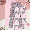 Two pairs of leggings with different patterns on a pink textured surface.