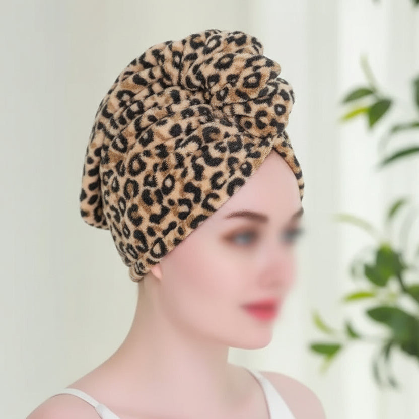 Person wearing a leopard print headscarf with a blurred background
