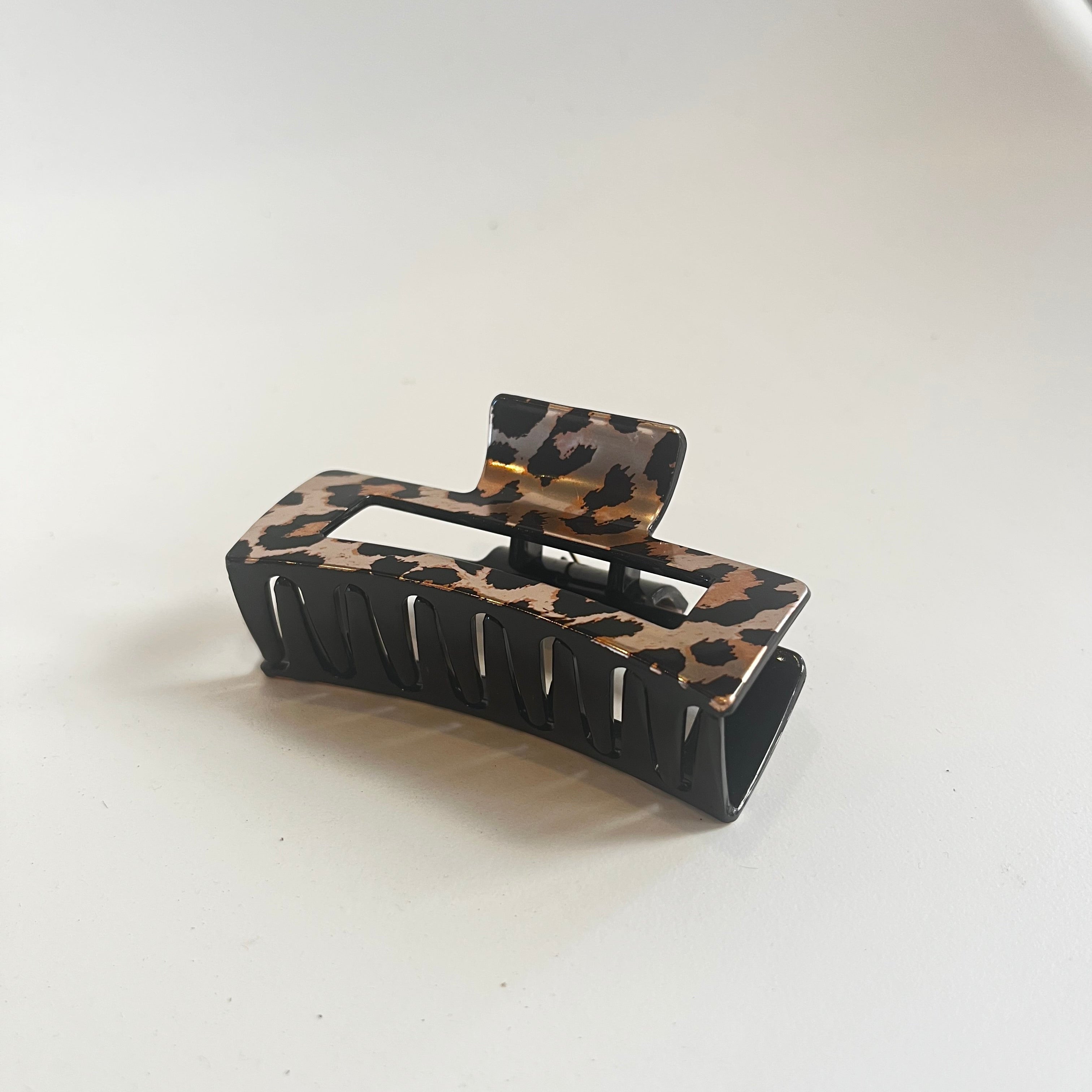 Leopard print hair clip on a white background