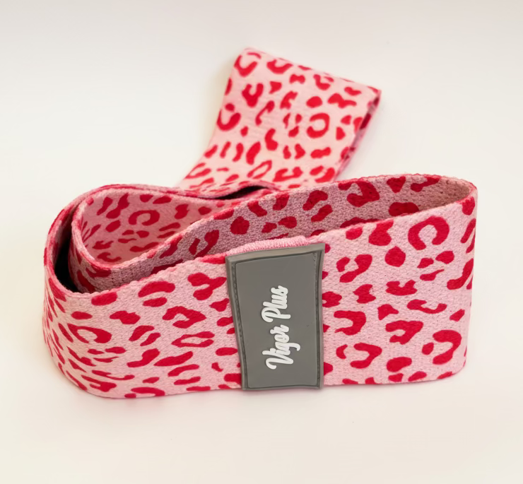 Pink leopard print belt with a brand label on a beige background