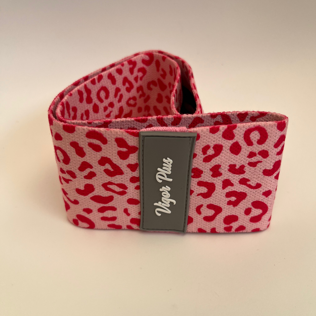 Red leopard print product with a visible brand label on a beige background