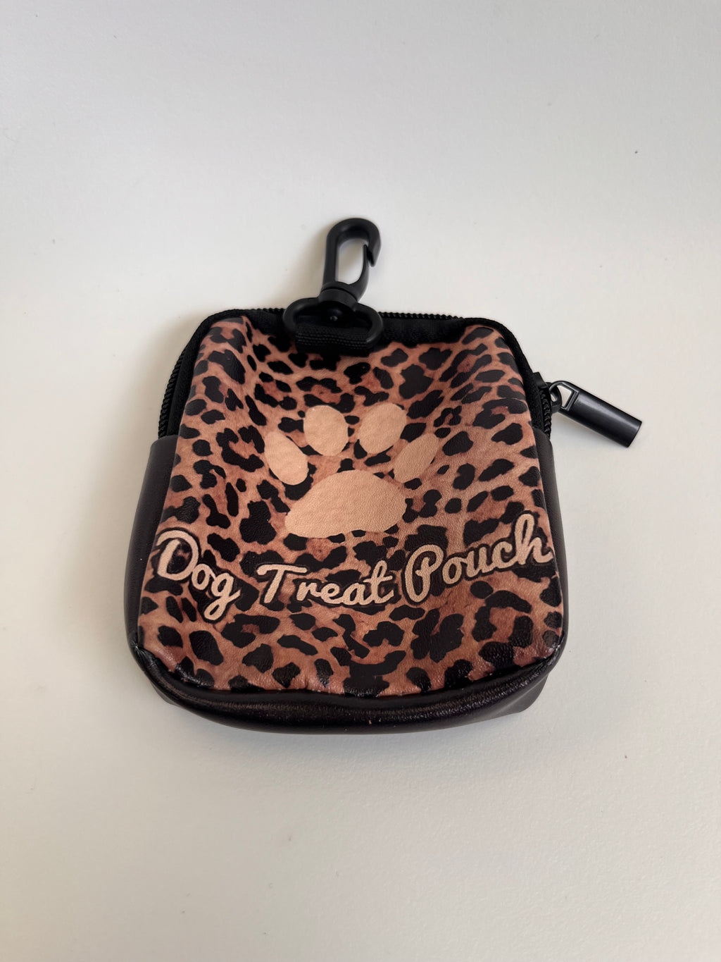 Leopard print dog treat pouch with a paw design on a white background