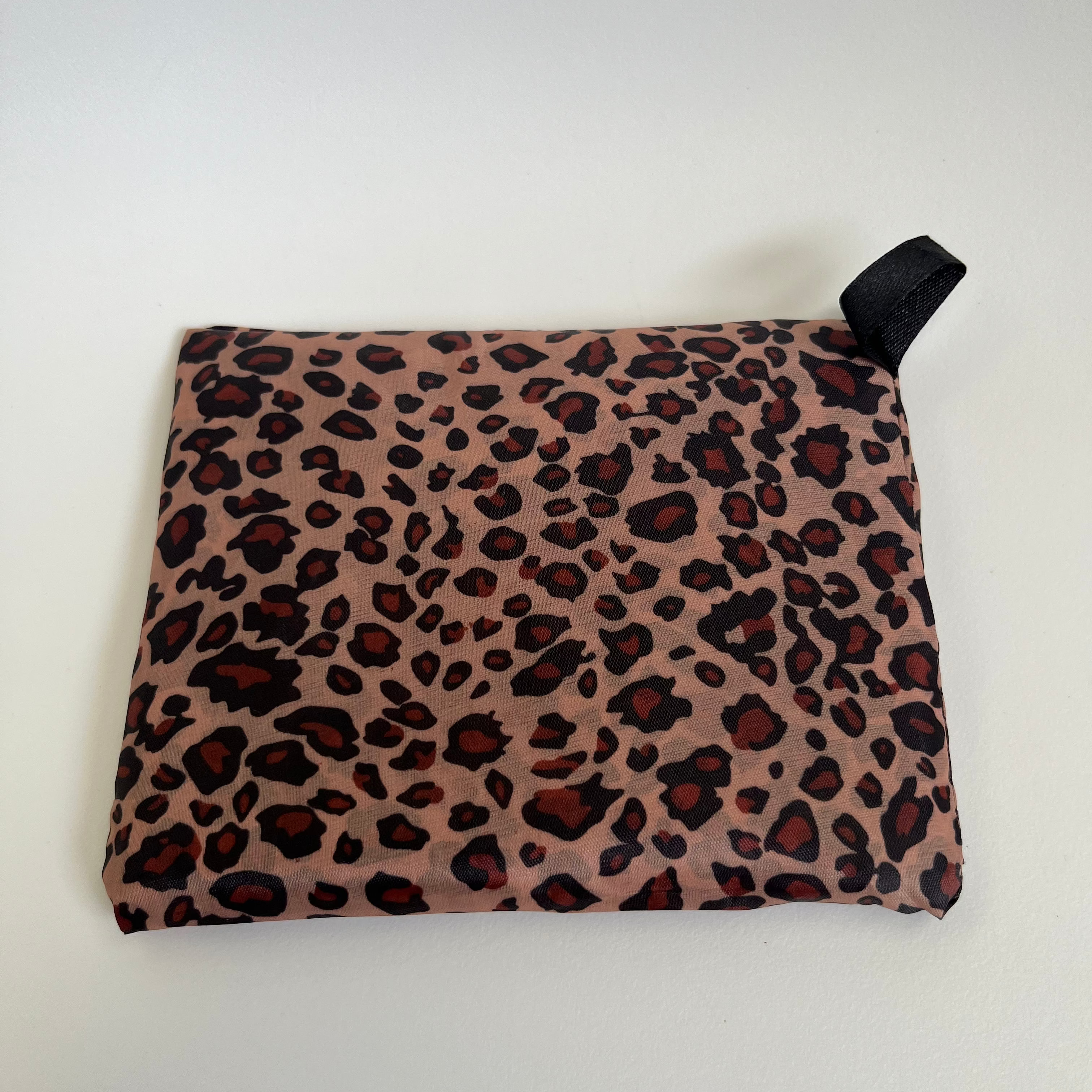 Leopard print pouch with a black zipper on a white background