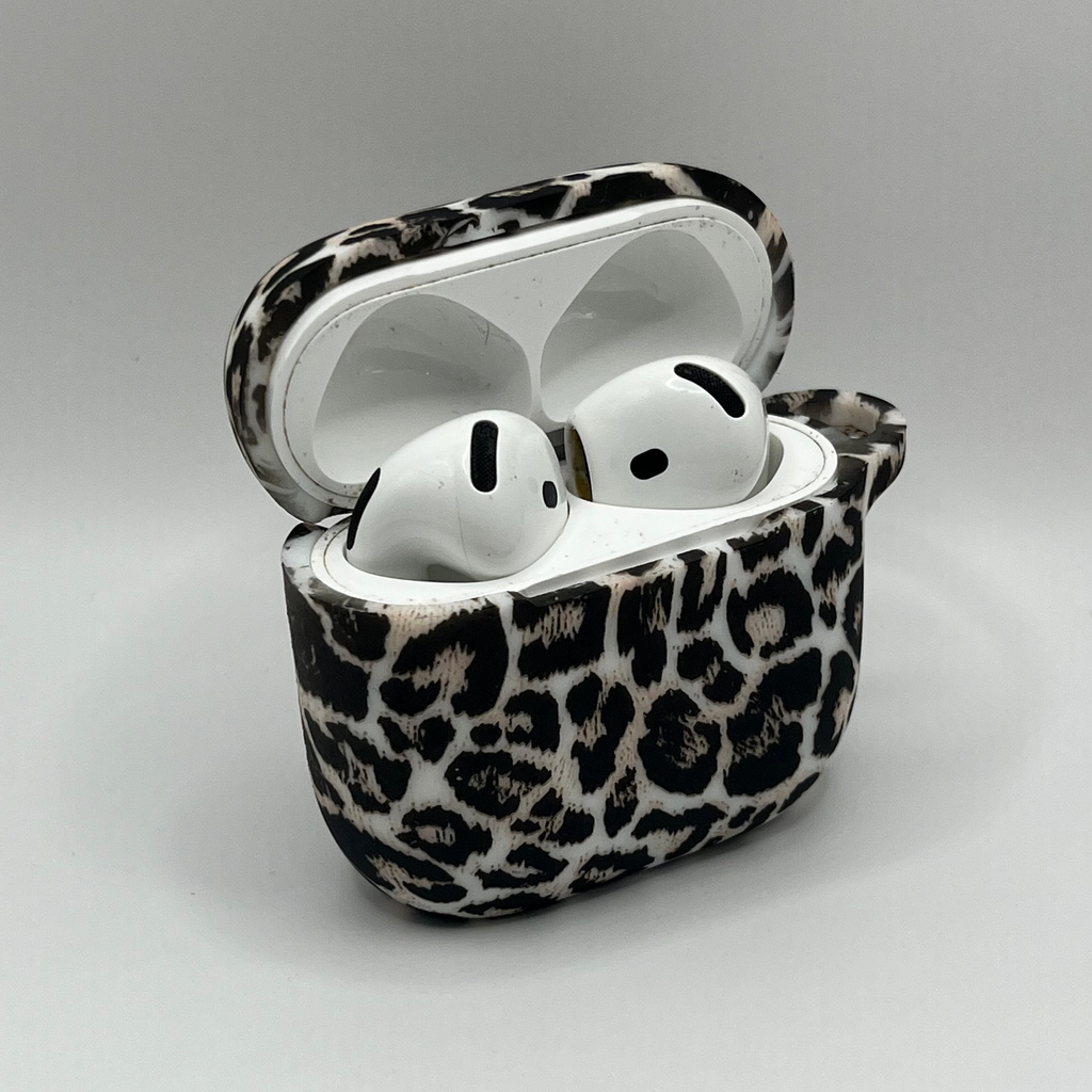 Leopard print case for wireless earbuds on a gray background