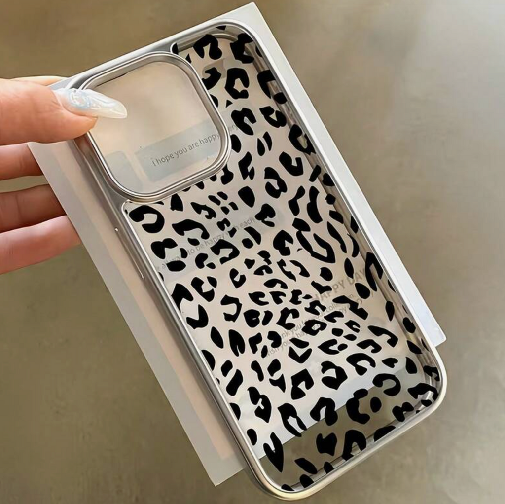 Phone case with leopard print held by a hand against a neutral background