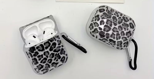 Two leopard print AirPod cases on a white background