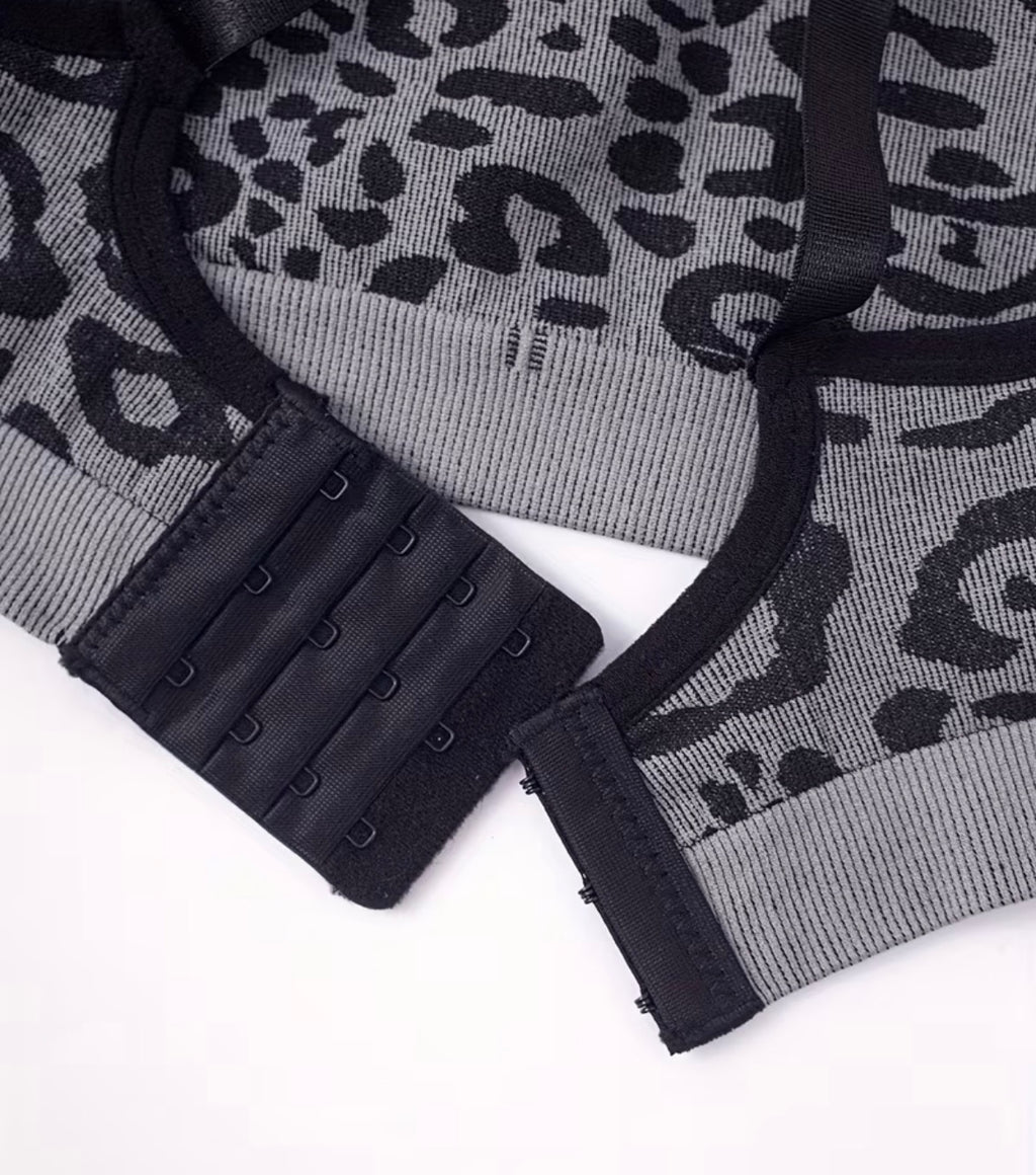 Gray bra with black leopard print details on a white background