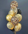 Bouquet of balloons with leopard print and gold colors against a dark background