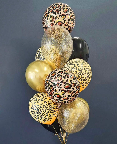 Bouquet of balloons with leopard print and gold colors against a dark background