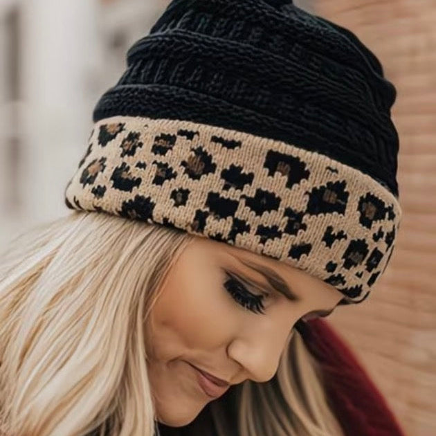 Woman wearing a black and leopard print beanie with a blurred background