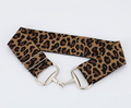 Leopard print belt with silver buckle on a light gray background