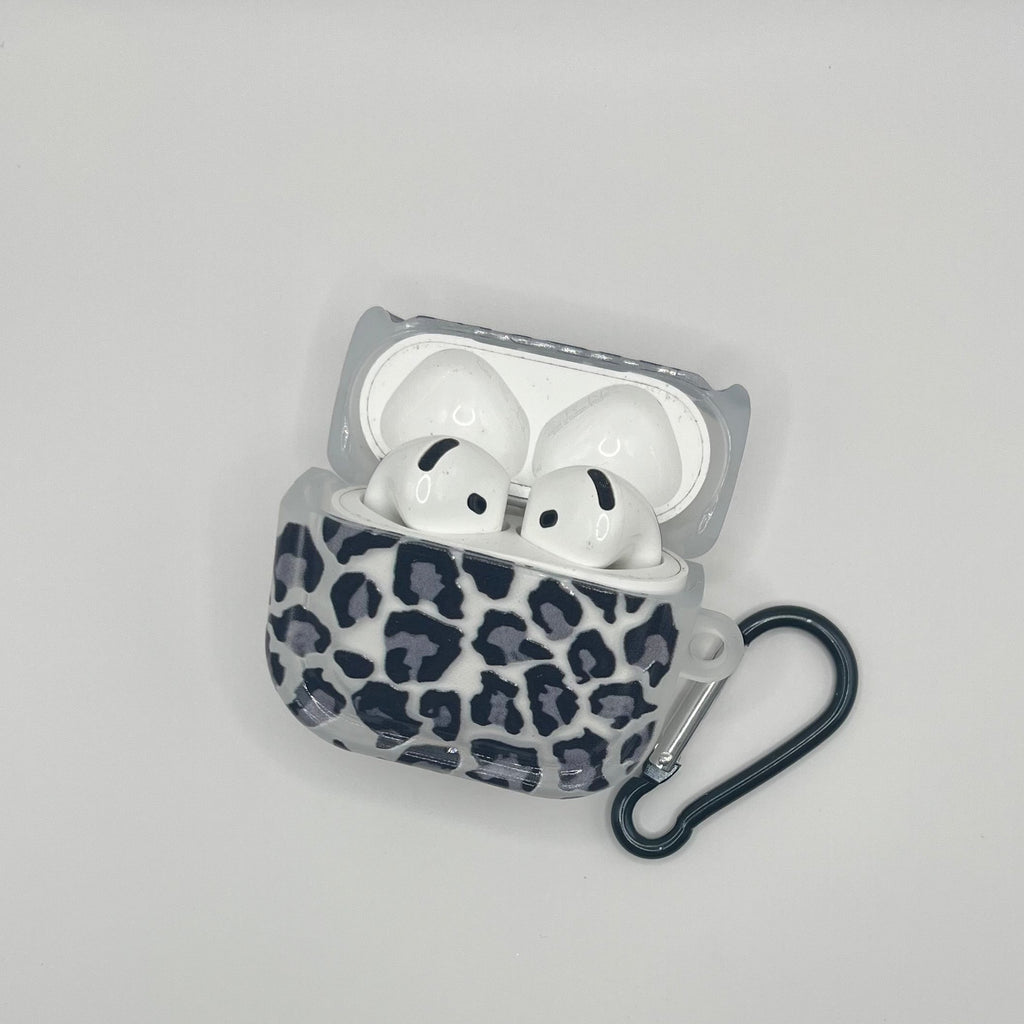 Leopard print airpod case with white airpods on a light gray background