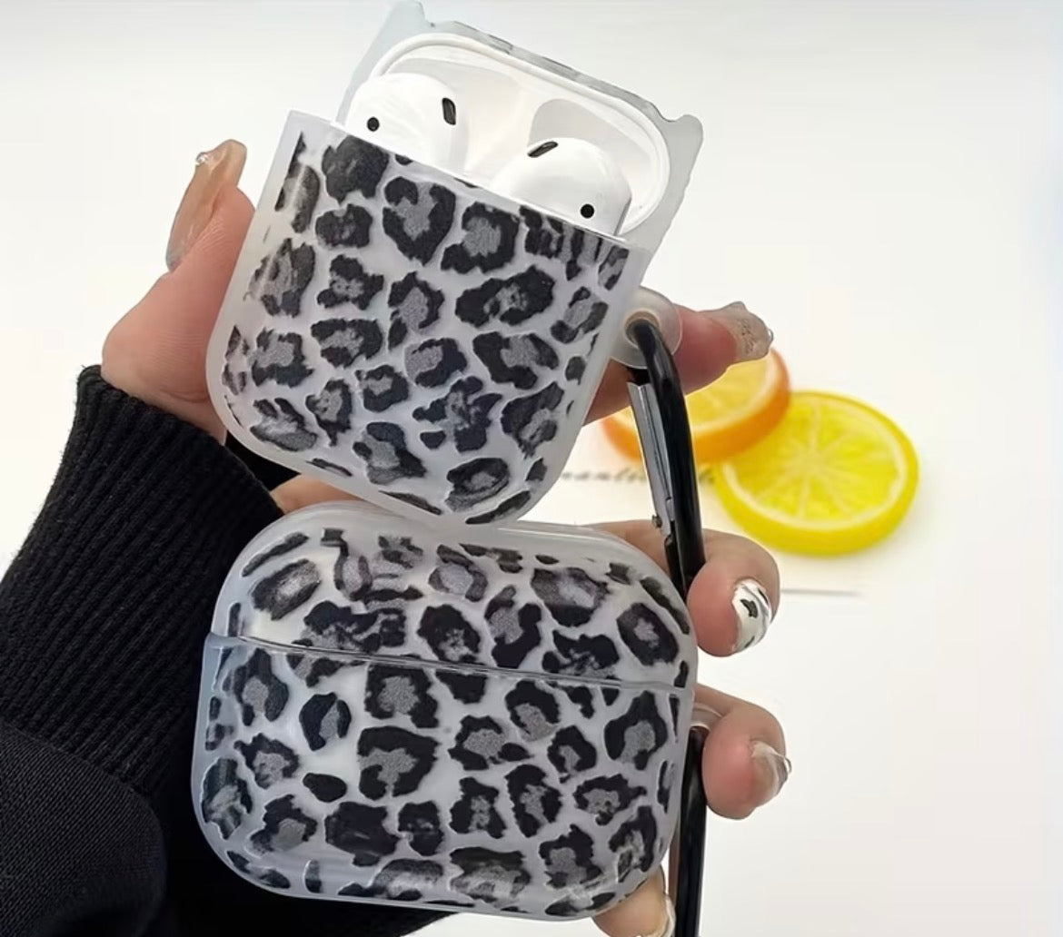 Leopard print AirPod cases held by a person with a blurred background