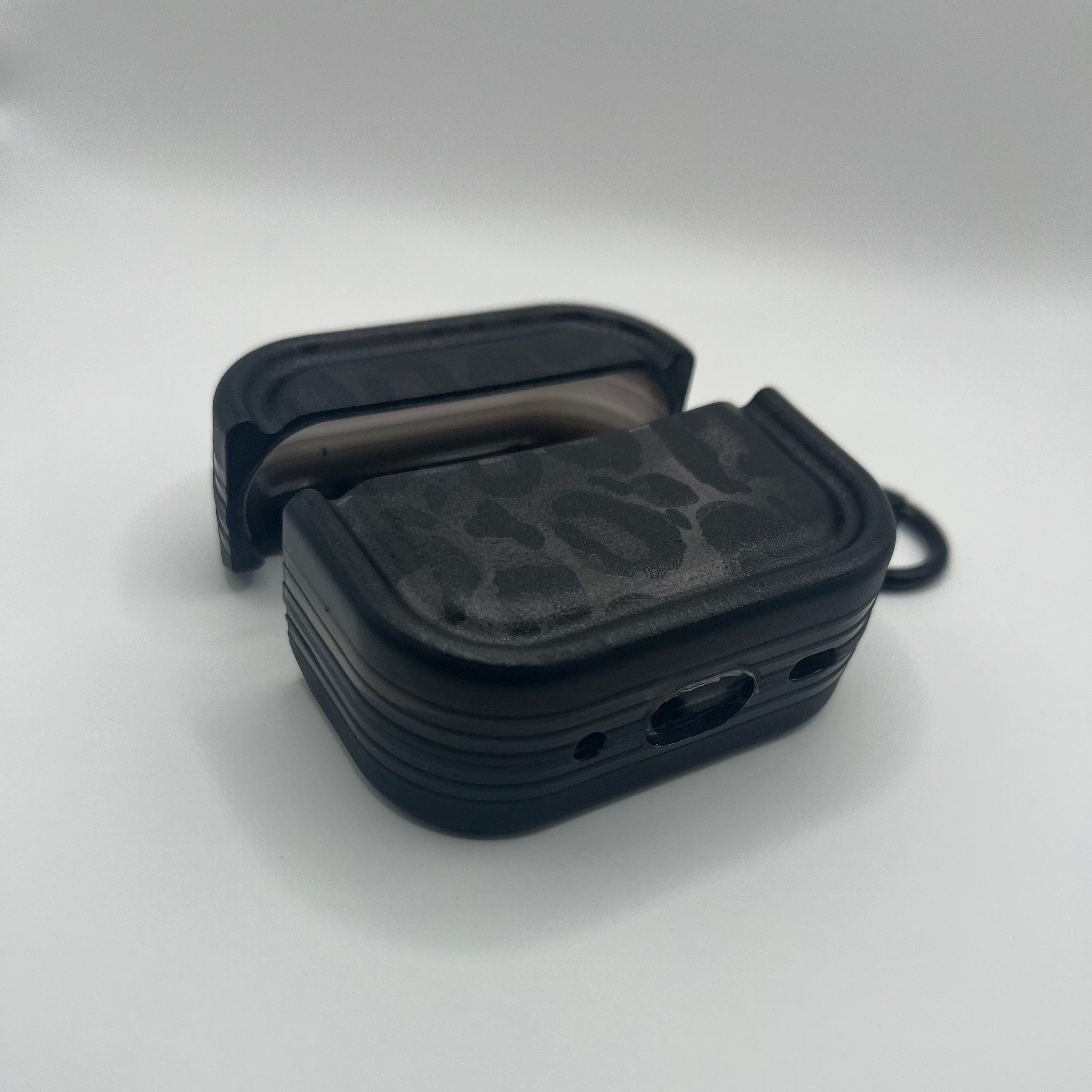 Black plastic airpod cover on a white background