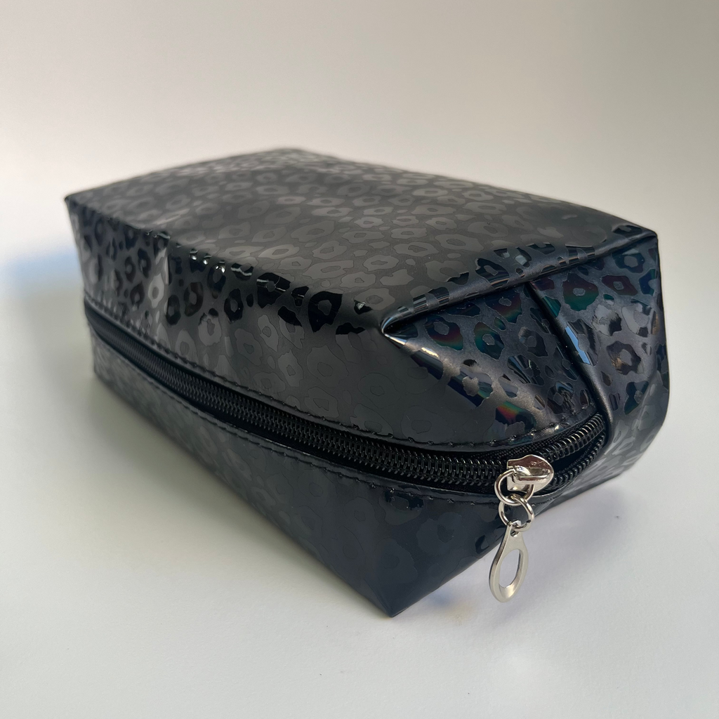Black leopard print makeup bag with a silver zipper on a white background