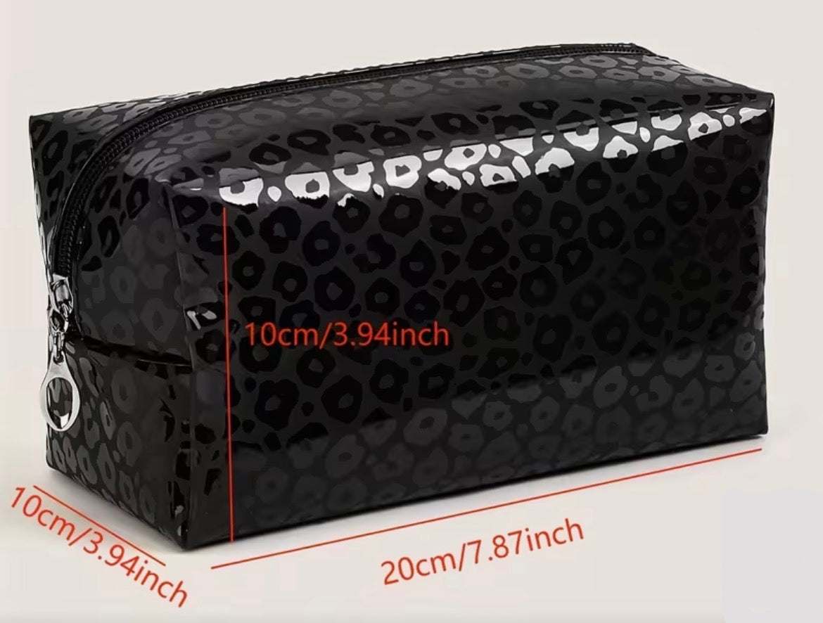 Black patterned cosmetic bag with measurements on a light gray background