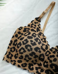 Leopard print bra with a beige strap on a white background
