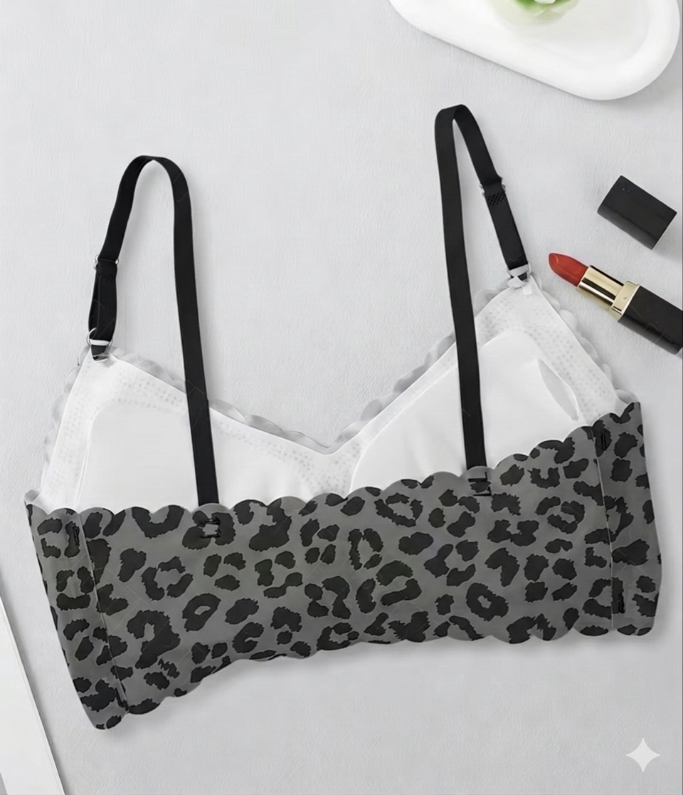 Leopard print bralette on a white background with makeup items.