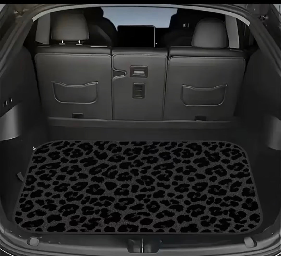 Car boot with a leopard print mat