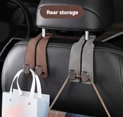 Car headrest organizer with straps and a shopping bag on a car seat.