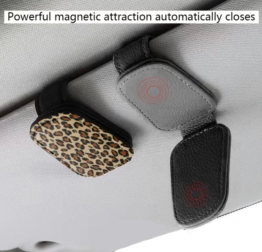 Car visor with a leopard print clip and text about magnetic attraction