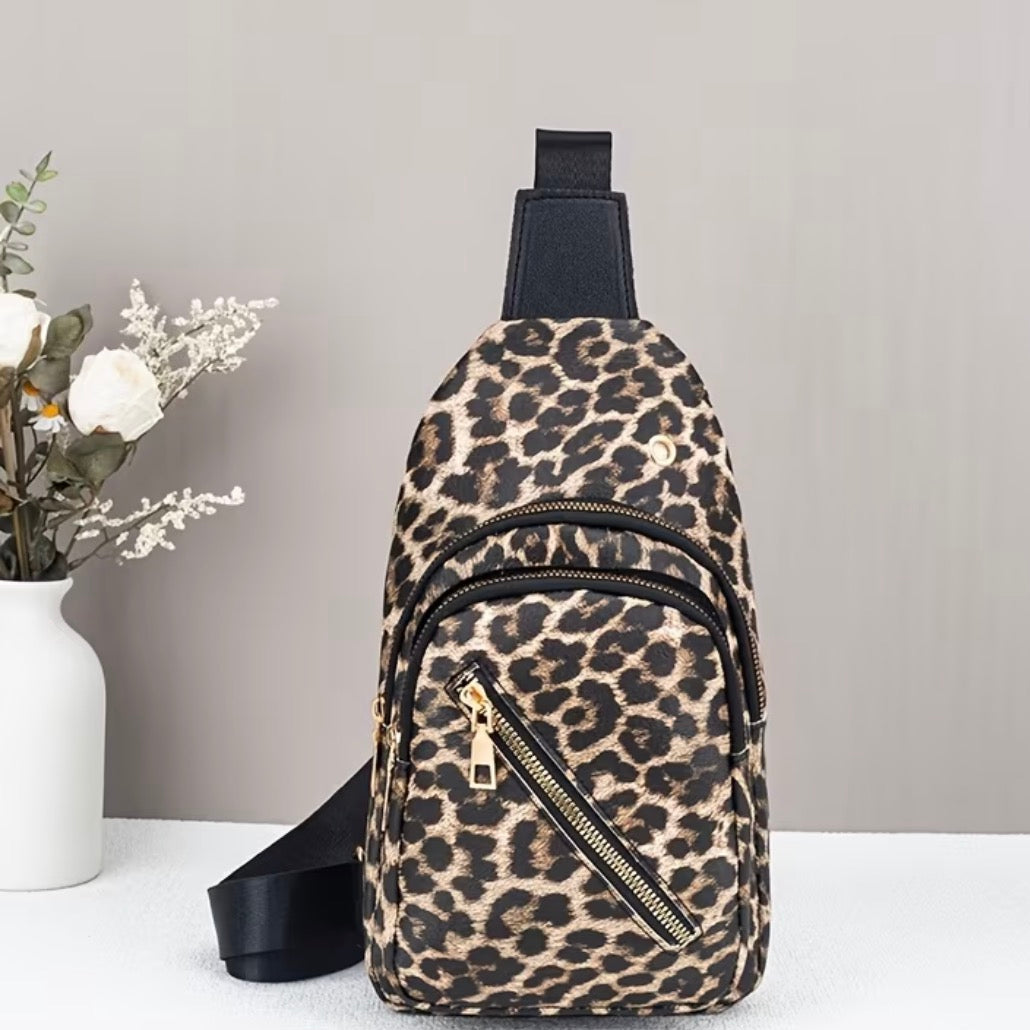 Leopard print sling bag on a white surface with a gray background