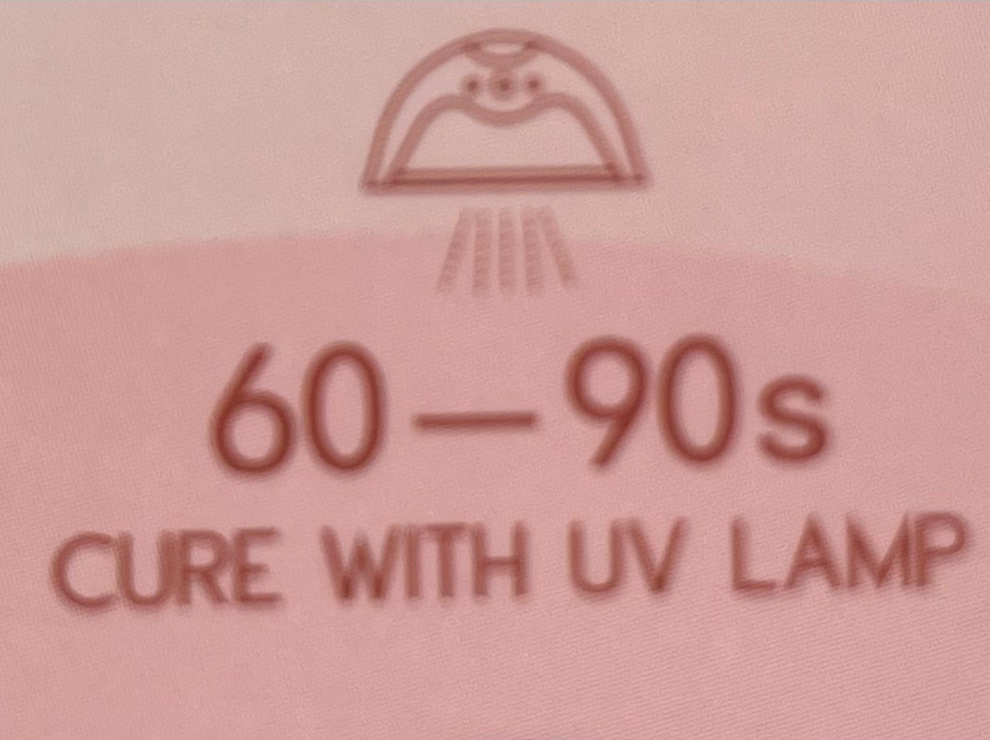 Text on a pink background indicating a cure time with UV lamp