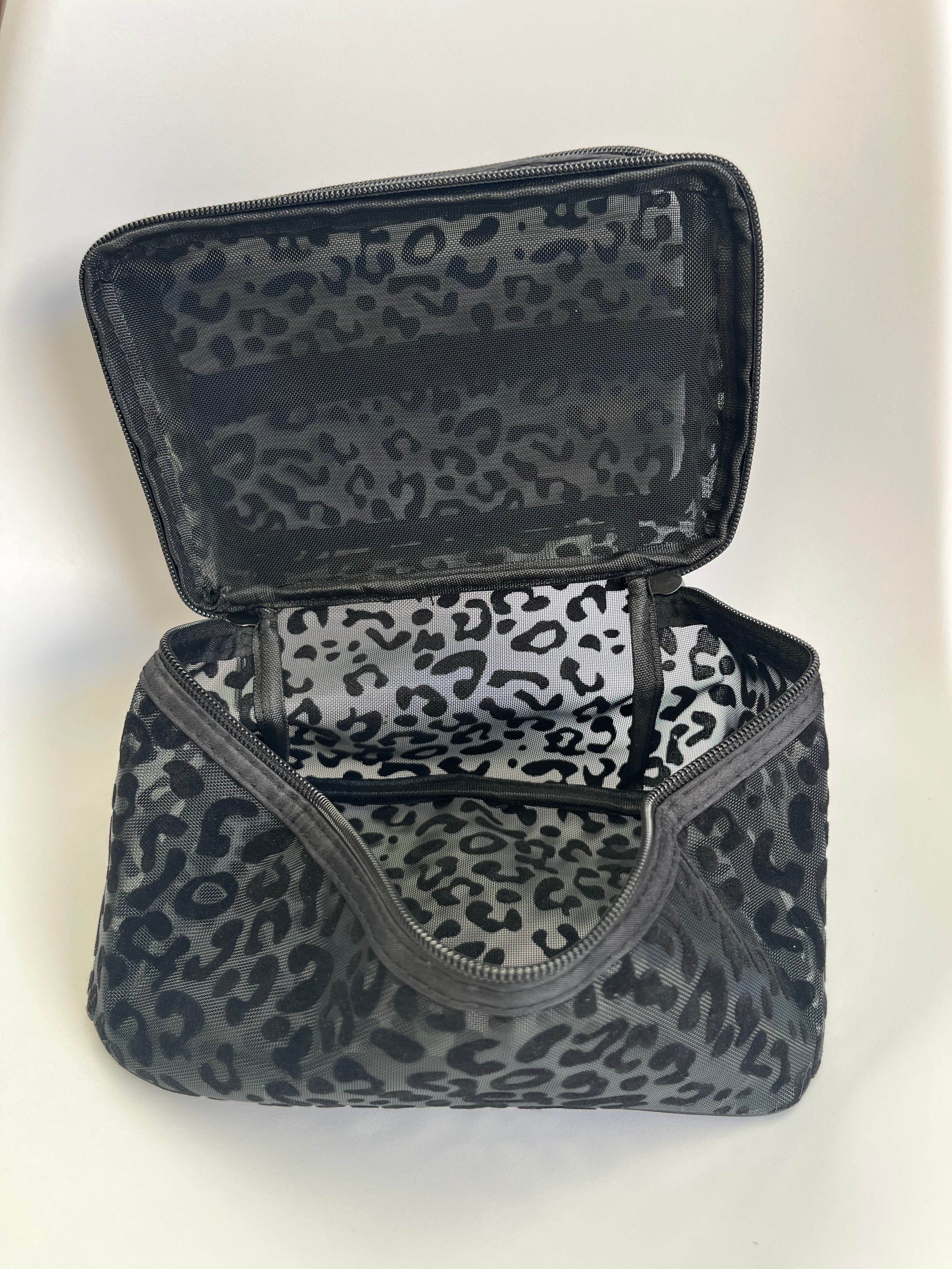 Black and white leopard print makeup bag on a white background
