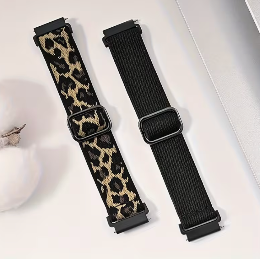 Two watch straps, one with a leopard print pattern and the other black, on a light background.