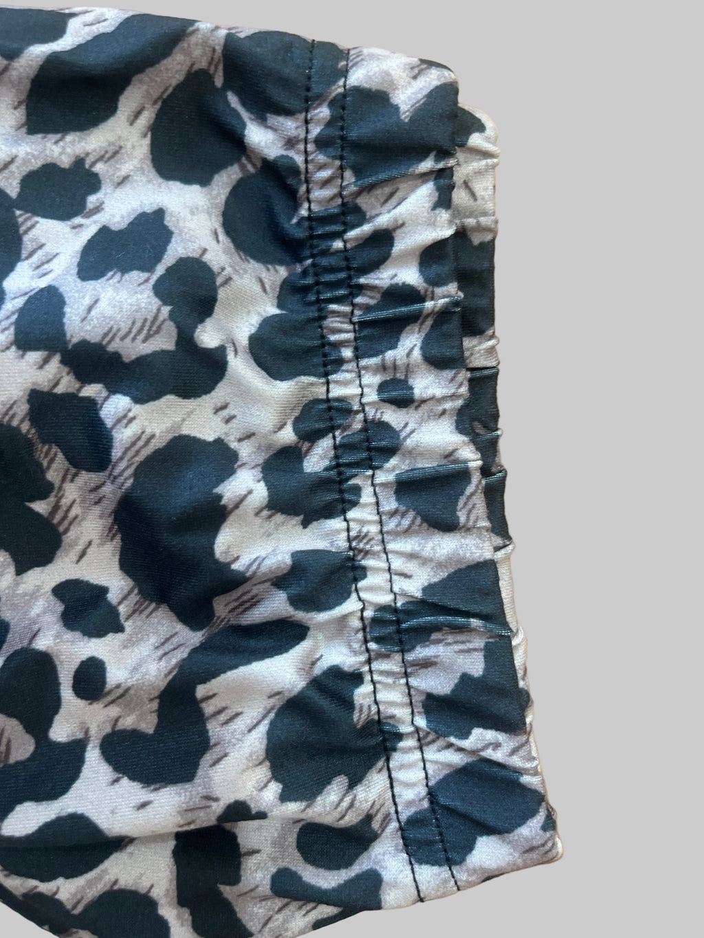 Black and white patterned shorts on a wooden surface
