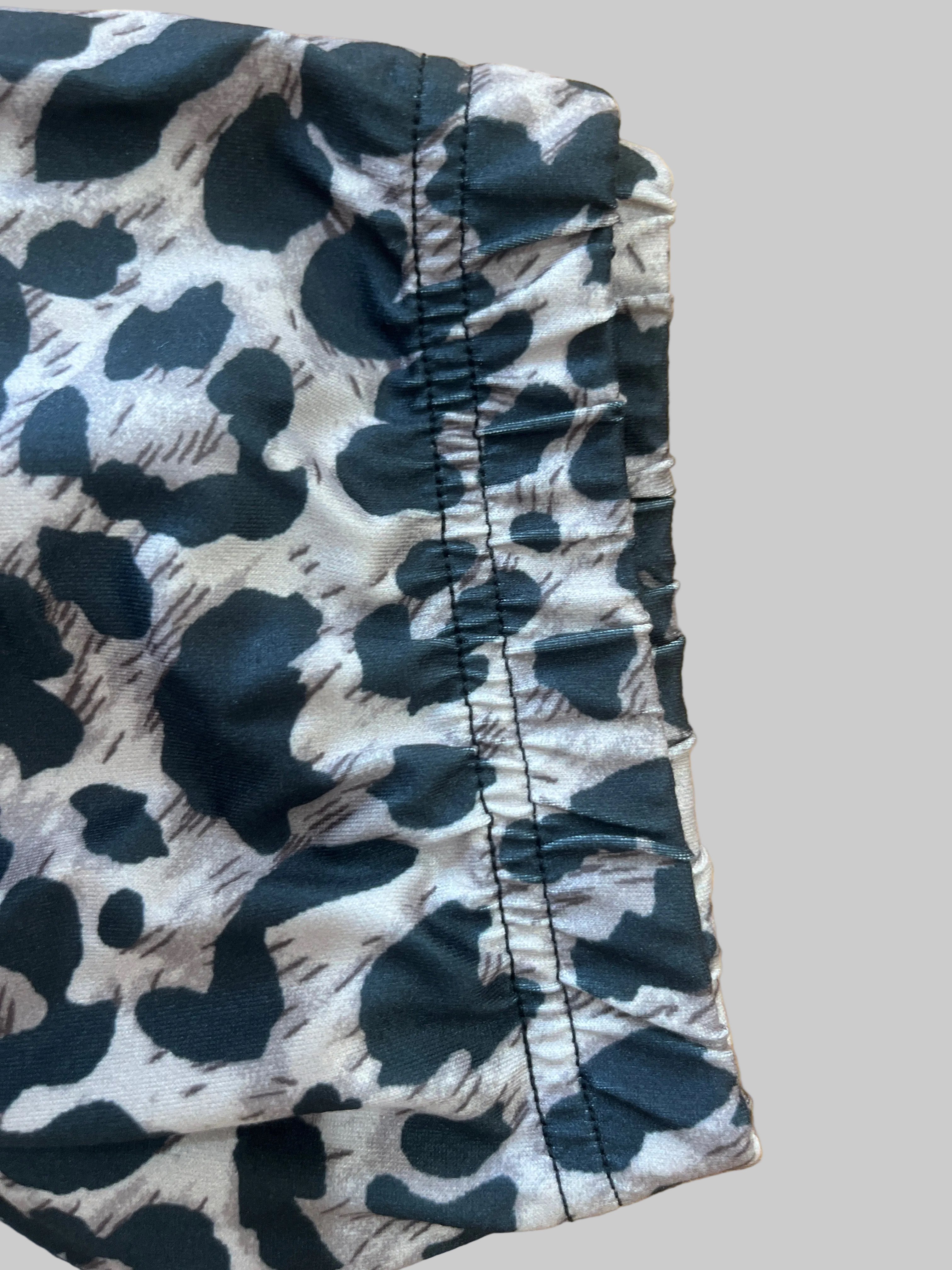 Black and white patterned shorts on a wooden surface