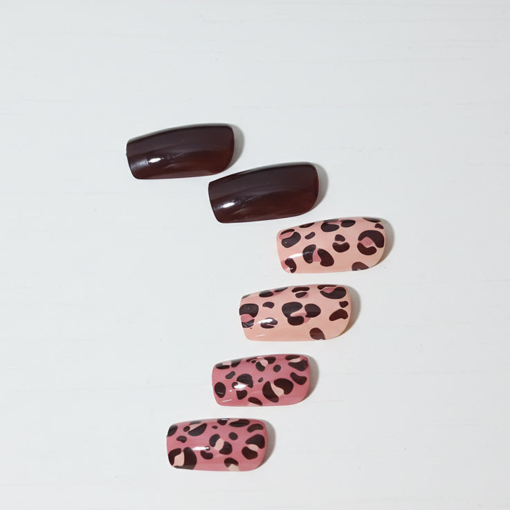 Set of false nails with leopard print design on a white background
