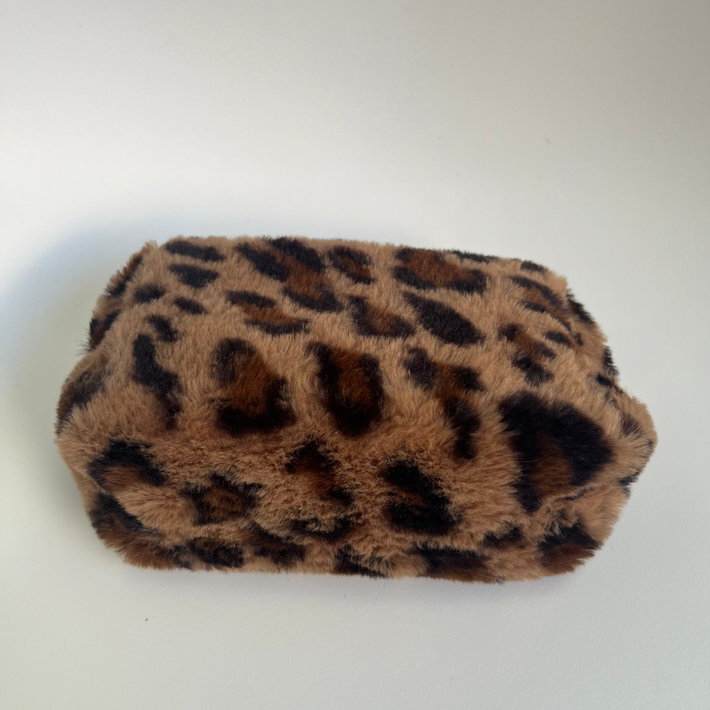 Leopard print makeup bag on a white background