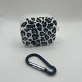 Leopard print case with a carabiner on a gray background