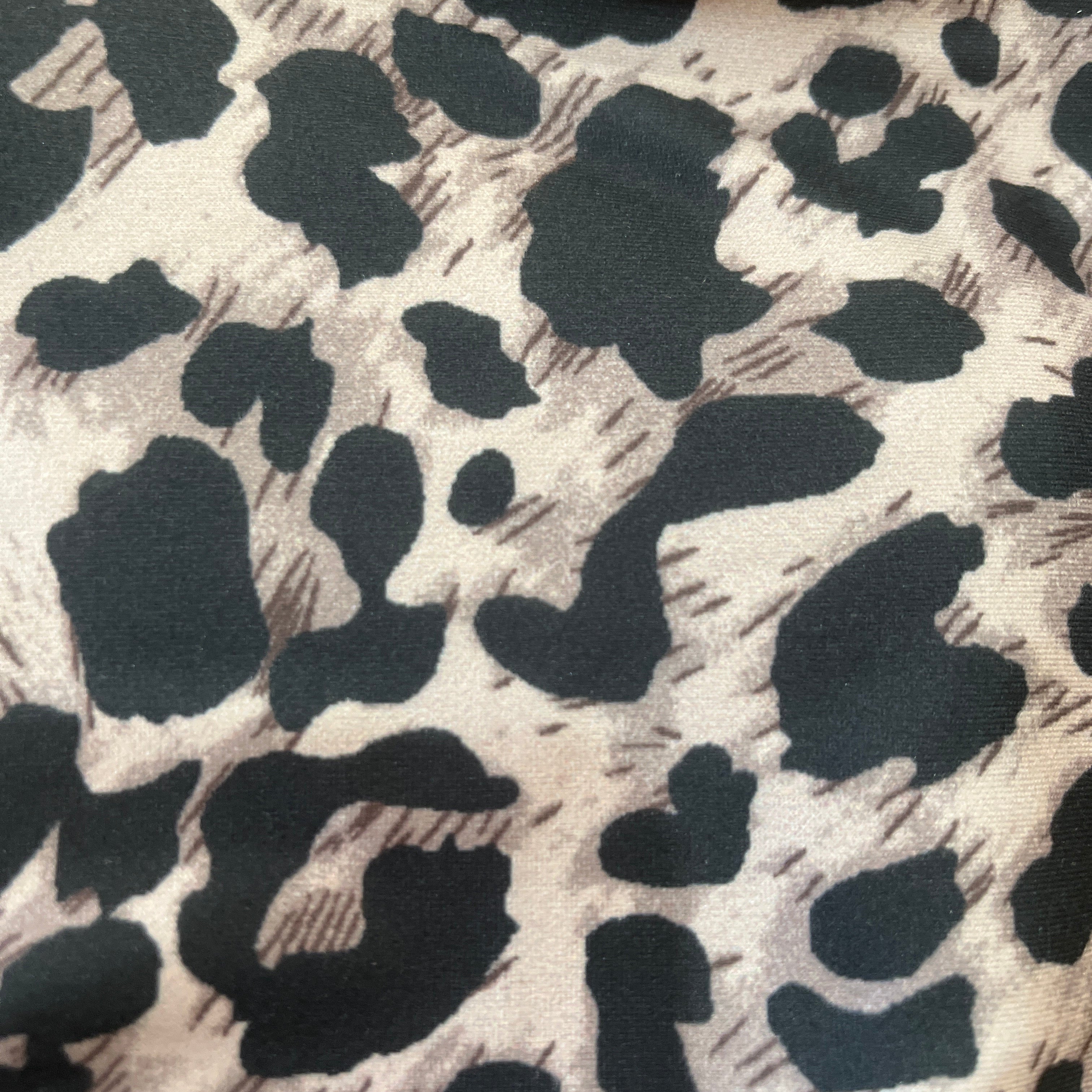 Close-up of fabric with black and white leopard print pattern