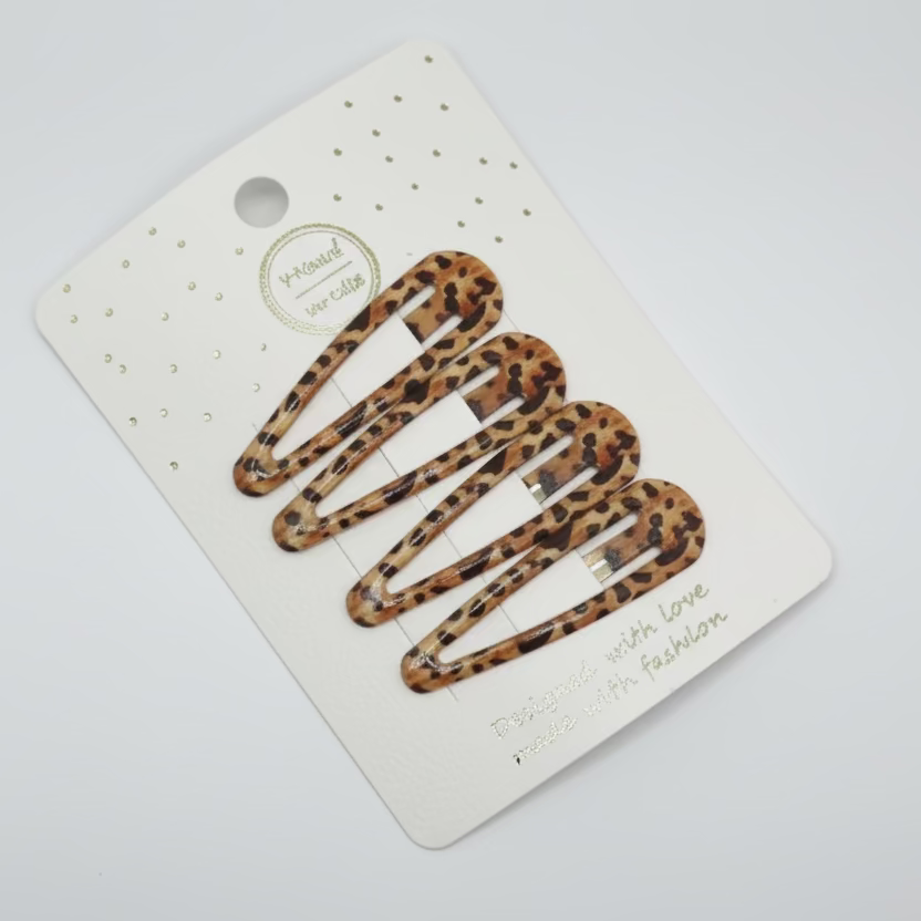 Leopard print hair clips on a branded card with a light gray background