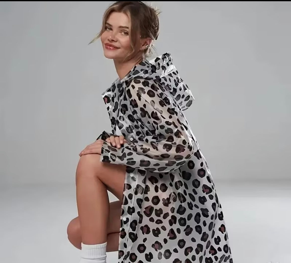 Woman wearing a leopard print raincoat on a plain background