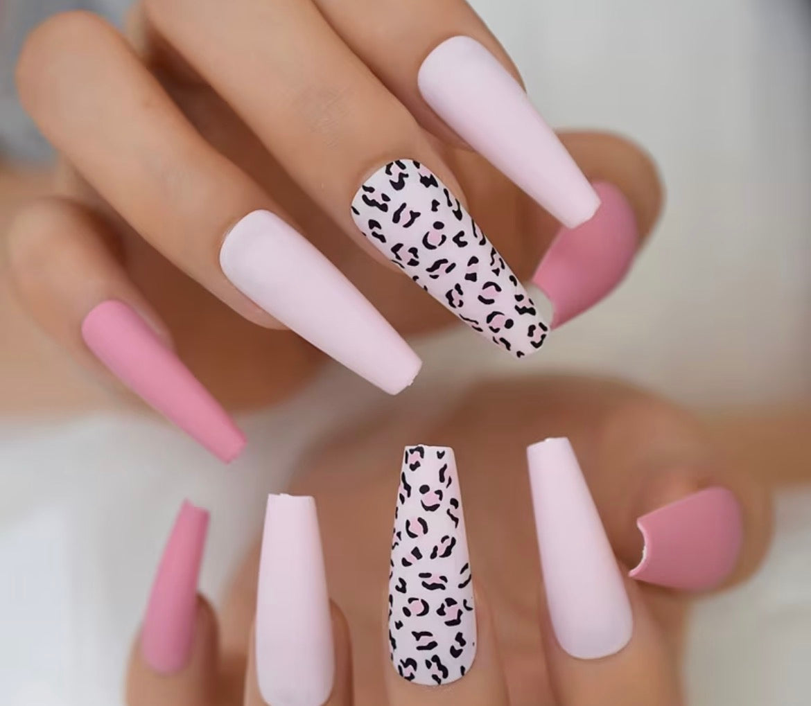 Nails with pink and leopard print design on a neutral background