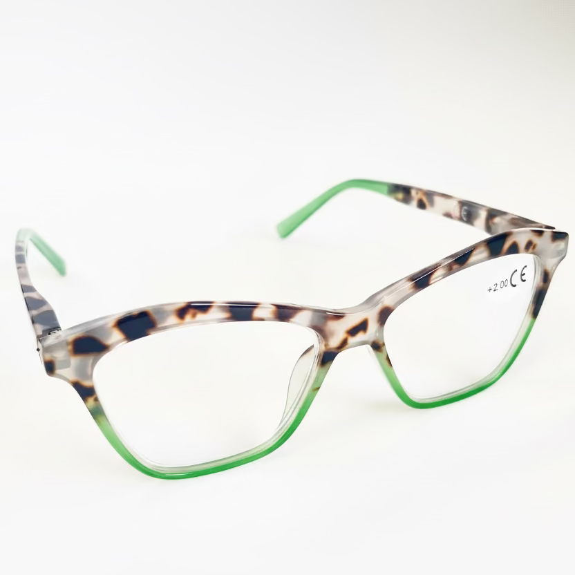 Eyeglasses with a leopard frame and green accents on a light gray background