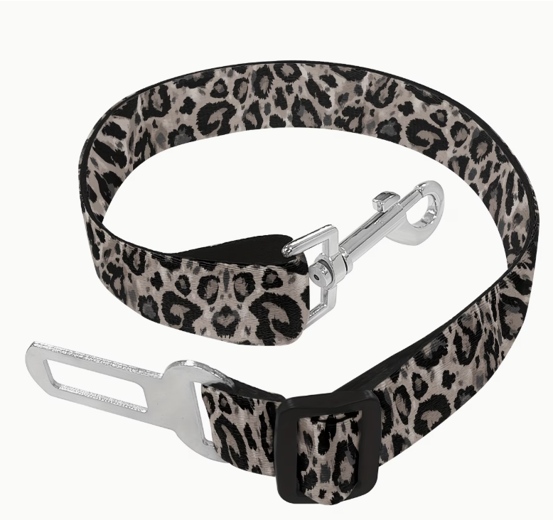 Leopard print seat belt with metal clip on a white background