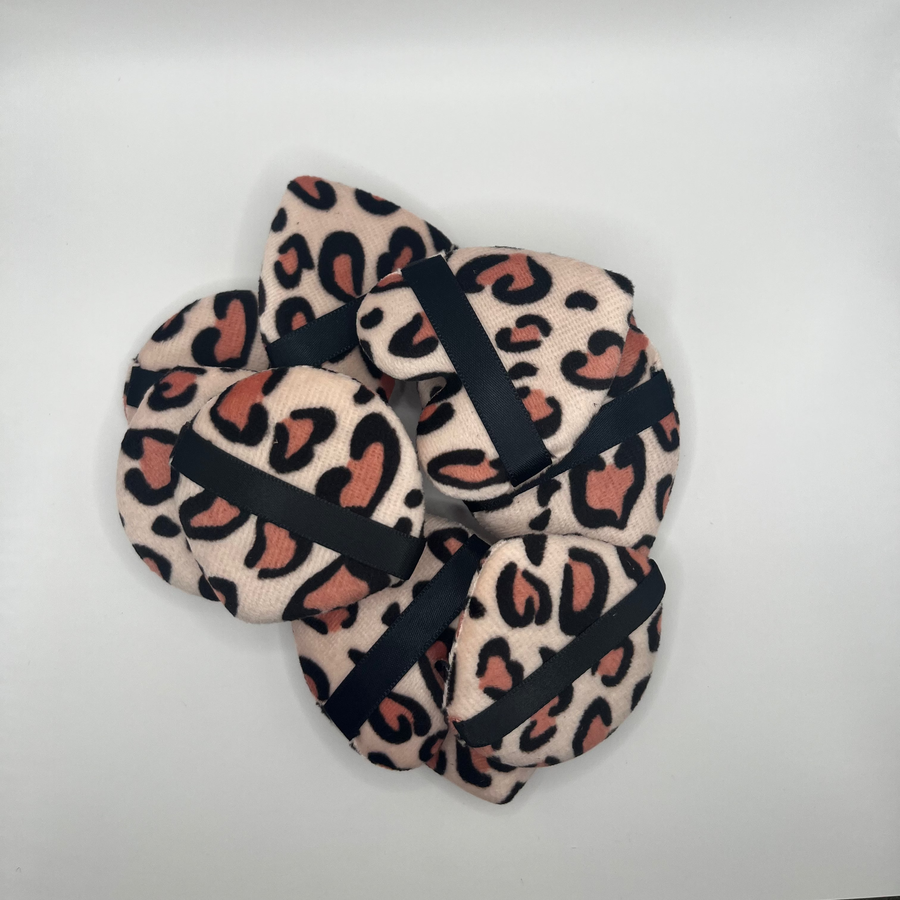 Pair of leopard print sponges on a white background