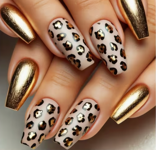Nails with gold and leopard print design on a neutral background