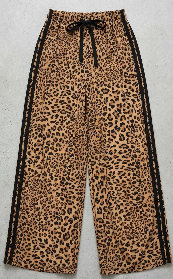Leopard print pants with black drawstring on a light gray background